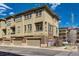 Stylish, multi-level townhome with brick accents and attached garage, set under a blue sky at 7837 Inverness Blvd, Englewood, CO 80112