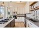 Modern kitchen showcasing white cabinets, stainless steel appliances, and a patterned backsplash at 7837 Inverness Blvd, Englewood, CO 80112