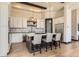 Bright kitchen features stainless steel appliances, a large island with seating and stylish pendant lighting at 7837 Inverness Blvd, Englewood, CO 80112