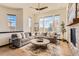 Bright and spacious living room with hardwood floors, a large sectional, and big windows at 7837 Inverness Blvd, Englewood, CO 80112