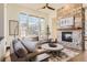 Inviting living room with a stone fireplace, hardwood floors, and a comfortable sectional sofa at 7837 Inverness Blvd, Englewood, CO 80112