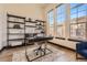 Well-lit office space featuring large windows, hardwood floors, and stylish black shelving at 7837 Inverness Blvd, Englewood, CO 80112