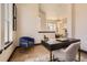 Office area featuring a modern desk, an accent chair, and hardwood floors at 7837 Inverness Blvd, Englewood, CO 80112