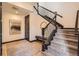 Inviting foyer with a carpeted staircase, a decorative mirror, and hardwood flooring at 7837 Inverness Blvd, Englewood, CO 80112
