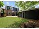 Backyard view features the house, garage, a patio, and lawn at 10109 E 28Th Ave, Denver, CO 80238