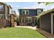 Wide backyard shot of patio, yard, garage, and the home's rear exterior at 10109 E 28Th Ave, Denver, CO 80238