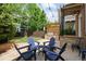 Backyard patio with grill, a pergola, and blue Adirondack chairs is ideal for outdoor gatherings at 10109 E 28Th Ave, Denver, CO 80238