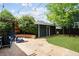 Backyard boasts a brick patio, string lights, and a detached garage, perfect for outdoor entertaining at 10109 E 28Th Ave, Denver, CO 80238