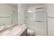 Bright bathroom featuring a glass-enclosed shower, vanity, and neutral color palette at 10109 E 28Th Ave, Denver, CO 80238