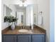 Tasteful bathroom with granite counters, grey cabinets, and ample mirror space at 10109 E 28Th Ave, Denver, CO 80238