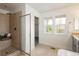 This bathroom features a shower, and a window at 10109 E 28Th Ave, Denver, CO 80238