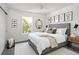 Brightly lit bedroom with a comfortable bed, stylish decorations, and a large window at 10109 E 28Th Ave, Denver, CO 80238