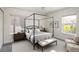 Spacious bedroom with a canopy bed, neutral tones, and bright lighting at 10109 E 28Th Ave, Denver, CO 80238