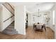 Bright dining room with a modern chandelier, wood floors, and light-filled windows at 10109 E 28Th Ave, Denver, CO 80238
