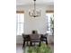 Well-lit dining space featuring modern chandelier, neutral walls, and wood floors at 10109 E 28Th Ave, Denver, CO 80238