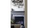 Elegant fireplace with decorative tile and modern art piece at 10109 E 28Th Ave, Denver, CO 80238