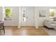 Welcoming foyer with light hardwood flooring, white trim and a view to the living space at 10109 E 28Th Ave, Denver, CO 80238