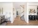Bright and spacious foyer with hardwood floors, leading to an elegant staircase and open living spaces at 10109 E 28Th Ave, Denver, CO 80238