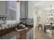 View of granite countertops, tile backsplash, and eat-in-kitchen next to the breakfast nook at 10109 E 28Th Ave, Denver, CO 80238