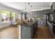 Open kitchen with a large island, dining area, granite countertops, and stainless steel appliances at 10109 E 28Th Ave, Denver, CO 80238