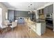 Stylish kitchen with an island, granite countertops, stainless steel appliances, and breakfast area at 10109 E 28Th Ave, Denver, CO 80238