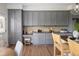 Charming kitchen featuring gray cabinets, granite countertops, and stainless steel appliances at 10109 E 28Th Ave, Denver, CO 80238