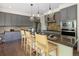 Modern kitchen featuring stainless steel appliances, pendant lighting, and a breakfast bar at 10109 E 28Th Ave, Denver, CO 80238