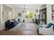 Bright living room with a fireplace, hardwood floors, and comfortable blue sofa at 10109 E 28Th Ave, Denver, CO 80238