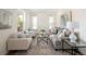 Bright and airy living room with hardwood floors, neutral decor, and a comfortable seating arrangement at 10109 E 28Th Ave, Denver, CO 80238