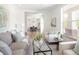 Inviting living room with an open layout, hardwood floors, and a view into the dining area at 10109 E 28Th Ave, Denver, CO 80238