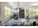 Cozy living room with fireplace, large windows, and modern decor at 10109 E 28Th Ave, Denver, CO 80238