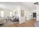 Stylish living room with hardwood floors, neutral decor, and ample natural light from windows and glass doors at 10109 E 28Th Ave, Denver, CO 80238