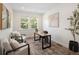 Inviting home office with a large window, comfortable seating, and calming decor at 10109 E 28Th Ave, Denver, CO 80238