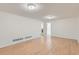 Finished basement area featuring light wood flooring and ample natural light at 2217 King St, Denver, CO 80211