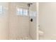 Modern bathroom with tiled walk-in shower and updated fixtures at 2217 King St, Denver, CO 80211