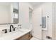 Bright bathroom with updated fixtures, a large mirror, and a view into the tiled shower at 2217 King St, Denver, CO 80211