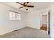 Bright bedroom with neutral carpet, white walls, ceiling fan, and a window with neighborhood views at 2217 King St, Denver, CO 80211