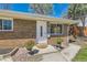 Inviting front entrance with a white door, flower planters, and manicured landscaping at 2217 King St, Denver, CO 80211