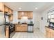 Bright kitchen with granite counters, stainless appliances, and white tile flooring at 2217 King St, Denver, CO 80211