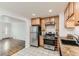 Bright kitchen with stainless steel appliances, light wood cabinets, and adjacent living space at 2217 King St, Denver, CO 80211
