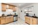 Bright kitchen featuring a window over the sink, stainless steel appliances, and tile floors at 2217 King St, Denver, CO 80211