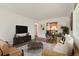 Open-concept living room showcases hardwood floors, a comfortable sofa, stylish furniture and a view of the kitchen at 2217 King St, Denver, CO 80211