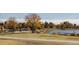 Picturesque park featuring picnic tables, mature trees, and a serene lakeside setting at 2217 King St, Denver, CO 80211