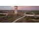 Close aerial view of The Aurora Highlands community entrance and residences in the distance at 23738 E 42Nd Ave, Aurora, CO 80019