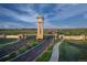 Grand entrance to The Aurora Highlands community with a clock tower and landscaped surroundings at 23738 E 42Nd Ave, Aurora, CO 80019