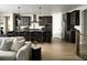 Open-concept kitchen with dark cabinetry, a large island, and modern appliances at 23738 E 42Nd Ave, Aurora, CO 80019