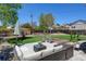 Backyard with a patio seating area, lush lawn, fire pit and a wooden fence at 10769 Carrol Ln, Northglenn, CO 80233