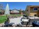 Backyard featuring a patio area with outdoor furniture, a fire pit, and a well-maintained lawn at 10769 Carrol Ln, Northglenn, CO 80233