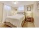 Cozy bedroom with a large bed, soft lighting from bedside lamps, and sheer curtains for natural light at 10769 Carrol Ln, Northglenn, CO 80233