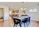 Open dining area flows into the updated kitchen featuring counter seating and stainless steel faucet at 10769 Carrol Ln, Northglenn, CO 80233